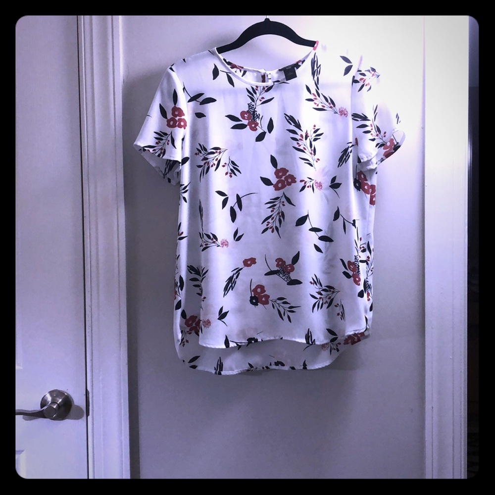 White blouse top with elegant print.